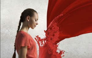 Girl opens bible with splashes of red for the Holy Spirit